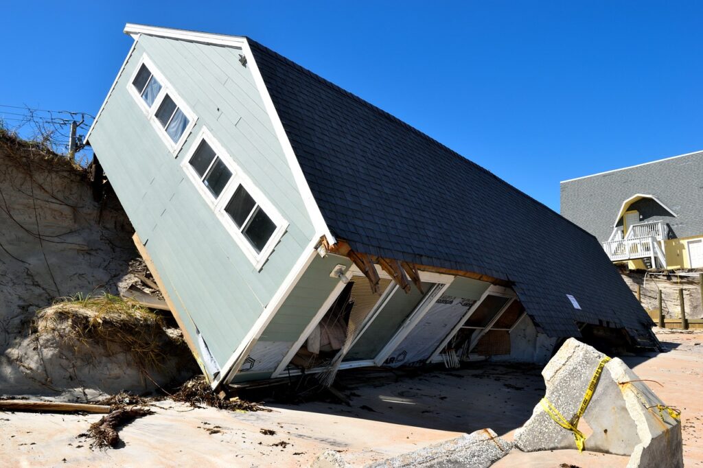 a mobile home that has tumbled to the its side because of a hurricane