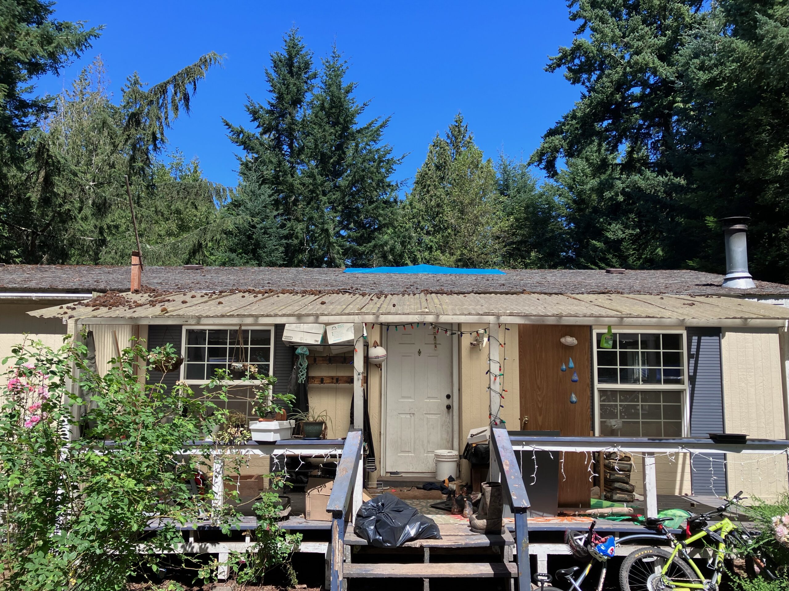 abandoned mobile home with junk outside