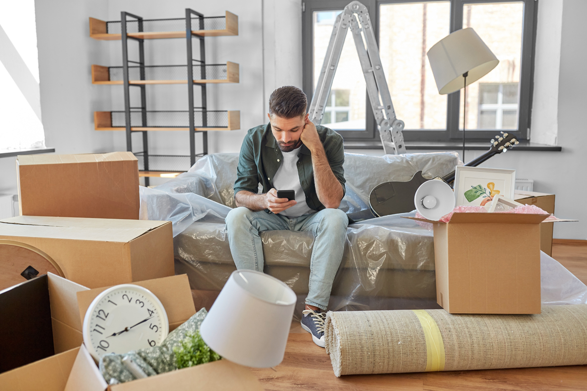 man in home with packed boxes